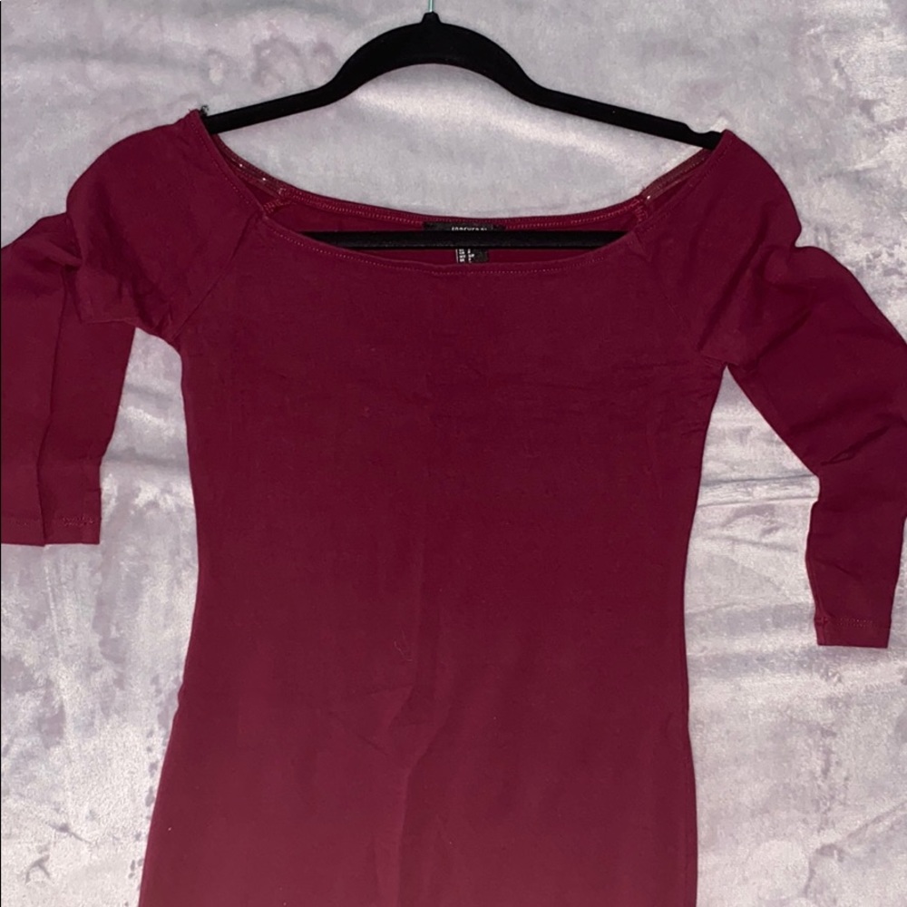 Off the shoulder burgundy dress.